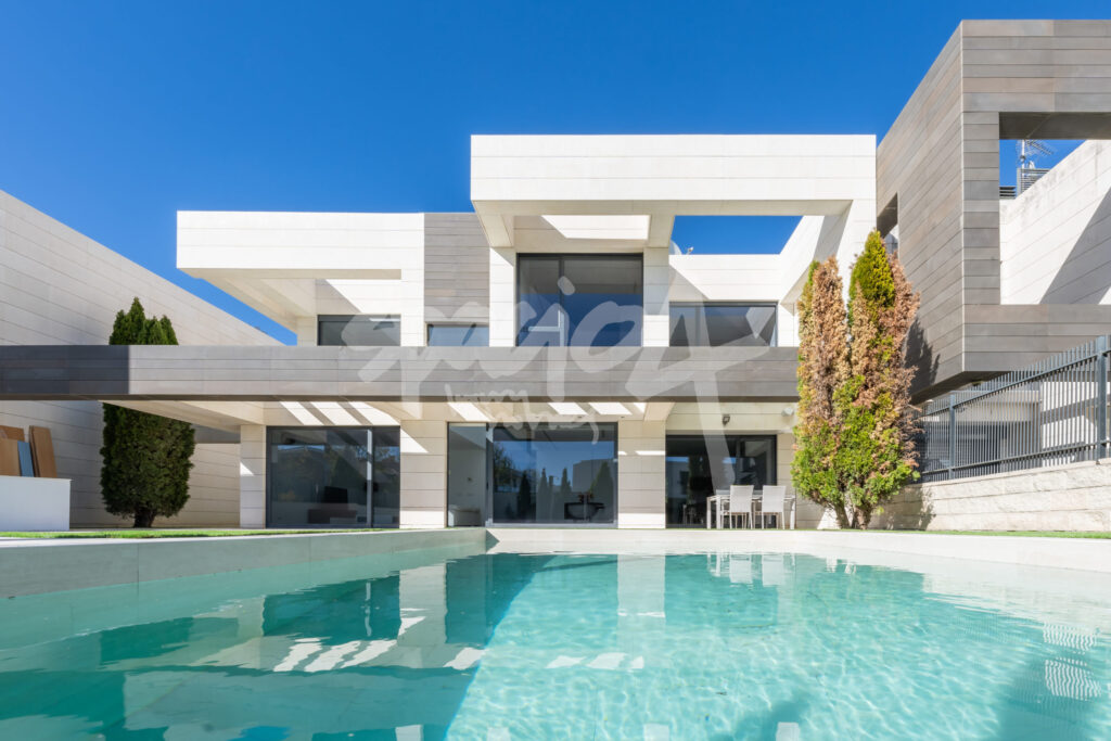 Vivienda unifamiliar moderna de dos alturas con piscina como ejemplo de aislamiento eficiente del hogar